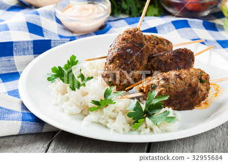 Barbecued kofta with rice on a plate 32955684