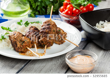 Barbecued kofta with rice on a plate 32955685