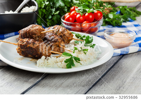 Barbecued kofta with rice on a plate 32955686