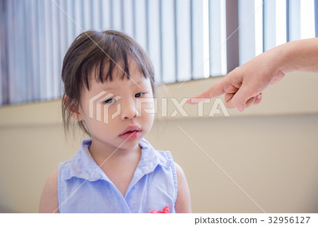 little girl doing sad face while mother scold her 32956127