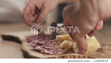 hands taking italian antipasti appetizers from 32960654