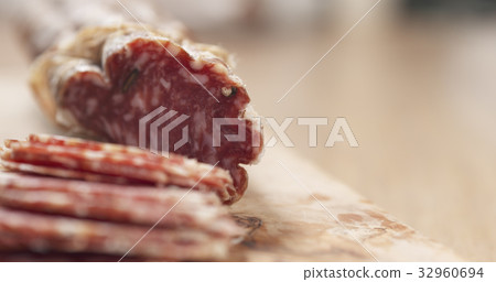 sliced dried italian salami on table sliced dried italian salami on table 32960694