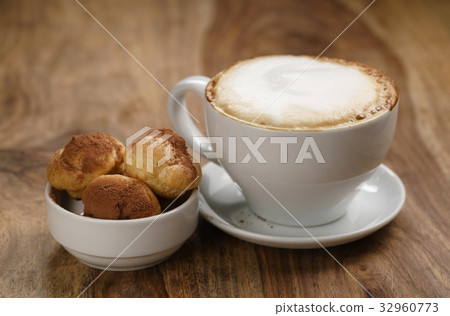 cappuccino with profiteroles on wood table 32960773