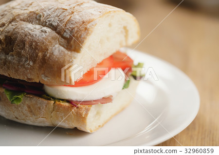 closeup shot of ciabatta sandwich with speck 32960859