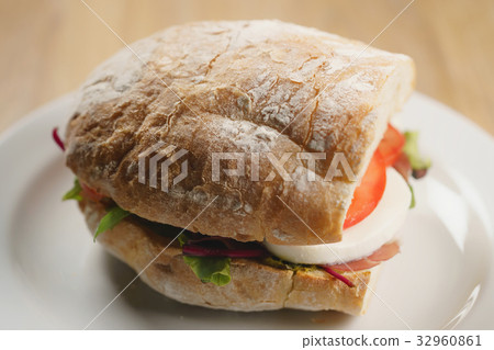 closeup shot of ciabatta sandwich with speck 32960861