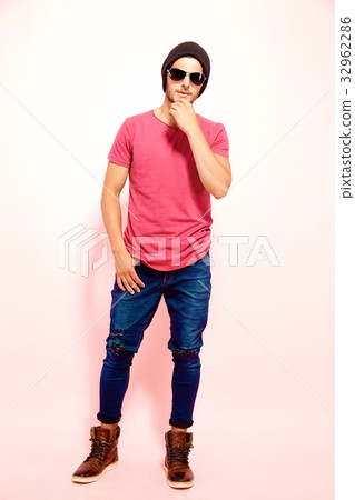 Guy touching chin holding hand in pocket Guy touching chin holding hand in pocket 32962286