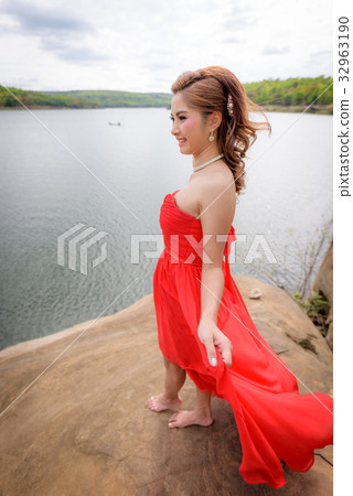 woman wear red evening dress enjoying mountain. woman wear red evening dress enjoying mountain. 32963190
