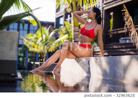 Beautiful slim sexy woman wearing red bikini relax Beautiful slim sexy woman wearing red bikini relax 32963628