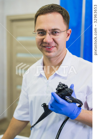 proctologist holding anoscope at hospital ward proctologist holding anoscope at hospital ward 32963653