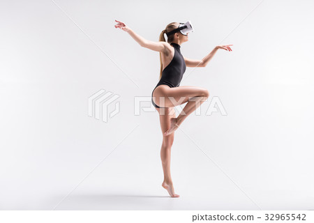 Pensive youthful girl dancing in goggles Pensive youthful girl dancing in goggles 32965542