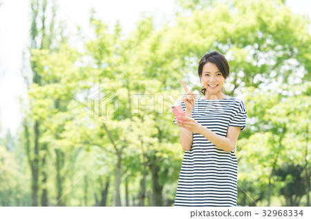 Woman with a mobile phone (green background) 32968334