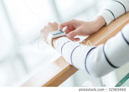 Woman touch on the screen of smart watch Woman touch on the screen of smart watch 32969468