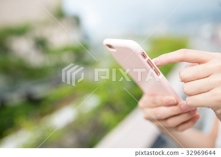 Woman use of cellphone at outdoor 32969644