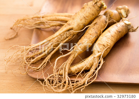 Fresh Korean Ginseng over wooden plate Fresh Korean Ginseng over wooden plate 32973180