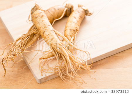 Fresh ginseng over wooden texture 32973313