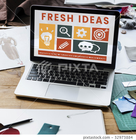 Laptop on the table with creative icons on screen 32973884