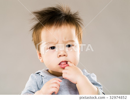 Little boy put finger into mouth Little boy put finger into mouth 32974852