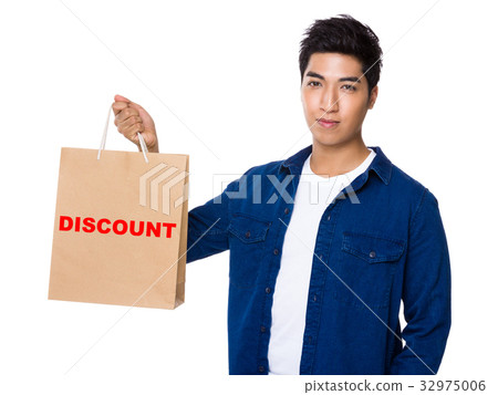 Man hold with shopping bag and showing a word discount 32975006