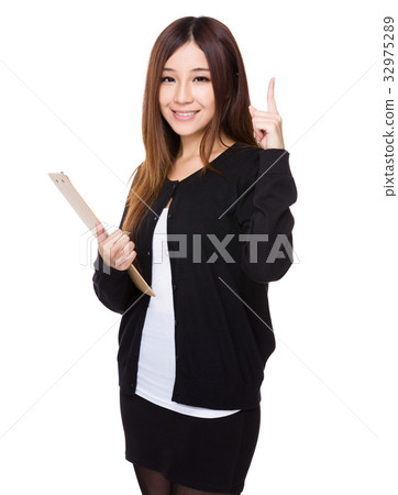 Asian young woman hold with clipboard and finger point up 32975289