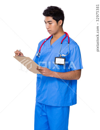 Male doctor take note on clipboard Male doctor take note on clipboard 32975381