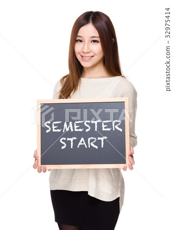 Woman hold with chalkboard showing phrases of semester start 32975414