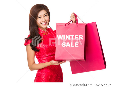 Chinese Woman hold with red paper bag and showing winter sale Chinese Woman hold with red paper bag and showing winter sale 32975596
