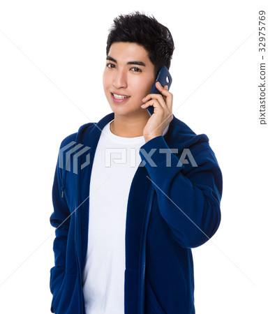 Asian Young Man chat on mobile phone Asian Young Man chat on mobile phone 32975769