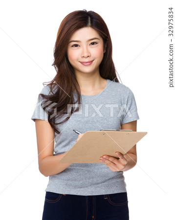 Asian Young Woman take note on clipboard Asian Young Woman take note on clipboard 32975834