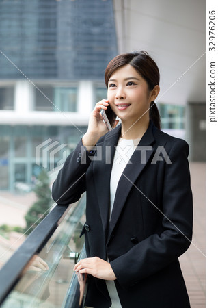 Young Businesswoman talk to mobile phone Young Businesswoman talk to mobile phone 32976206
