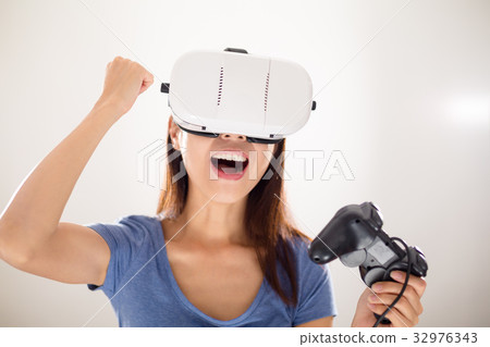 Woman play video game with virtual reality device 32976343