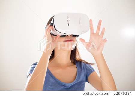 Asian Woman watching with VR device and hands up 32976384