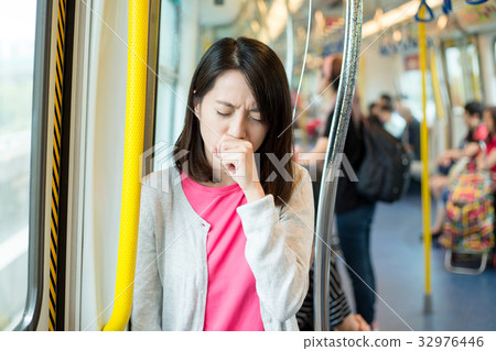 Woman feeling unwell inside train 32976446