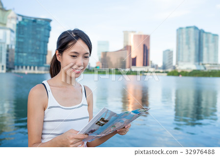 Woman using paper map in Macao city Woman using paper map in Macao city 32976488