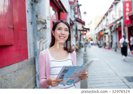 Woman looking for location in Macau city 32976524