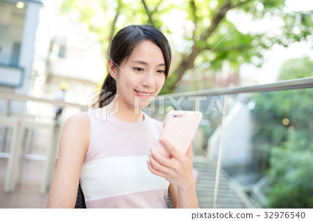 Woman use of mobile phone Woman use of mobile phone 32976540