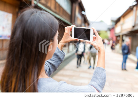 Woman taking photo in kanazawa city 32976803