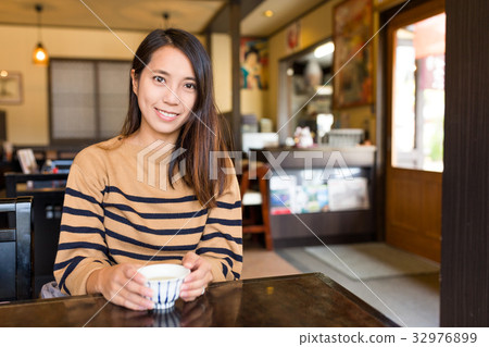 Woman in Japanese restaurant Woman in Japanese restaurant 32976899