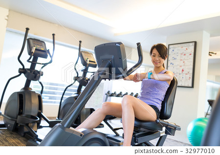 Woman cycling in gym 32977010