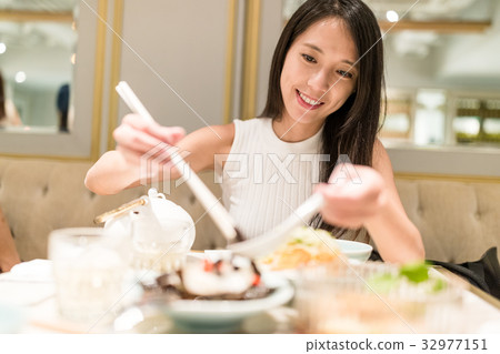 Woman enjoy dinner in restaurant 32977151