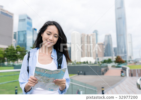 Woman use of city map in Hong Kong Woman use of city map in Hong Kong 32977200