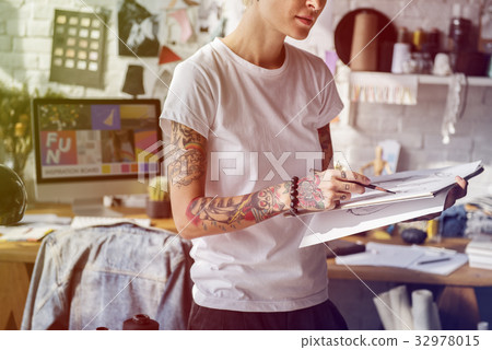 Fashion designer tattooed girl drawing cloth pattern Fashion designer tattooed girl drawing cloth pattern 32978015