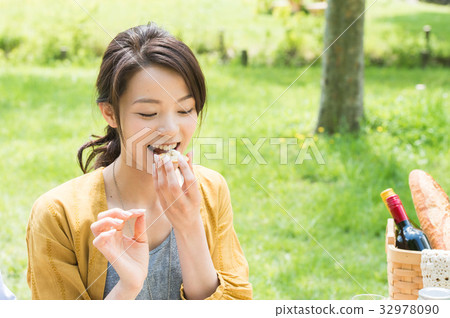 A woman enjoying a picnic 32978090