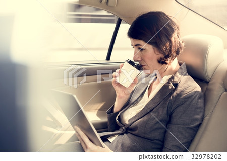 Businesswoman Using Tablet Car Inside Businesswoman Using Tablet Car Inside 32978202