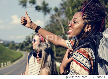 Group of Diverse Backpacker Woman Hitch Hiking on The Street Sid 32978551