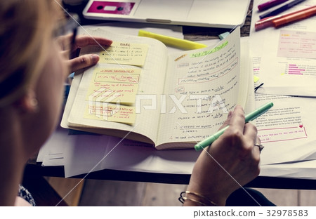 Student writing the lecture on wooden table Student writing the lecture on wooden table 32978583