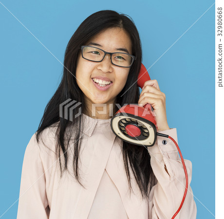 Asian girl talking by phone studio portrait Asian girl talking by phone studio portrait 32980668