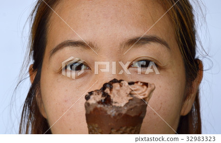 chocolate ice cream in front of woman eye 32983323