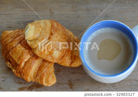 butter croissant and milk coffee on wooden board 32983327