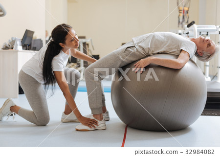 Relaxed pensioner stretching his back Relaxed pensioner stretching his back 32984082