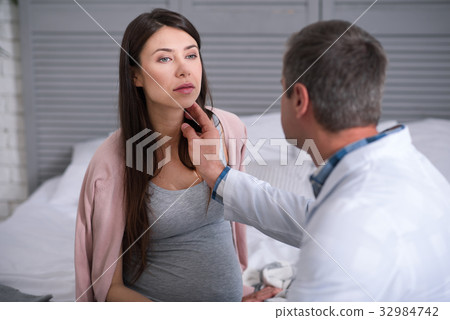 Concentrated pregnant woman being at consultation Concentrated pregnant woman being at consultation 32984742